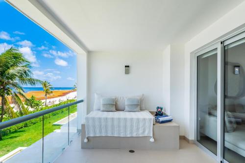 a bedroom with a bed and a view of the ocean at Mareazul Beach Front Condos At playa del Carmen in Playa del Carmen