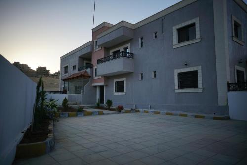 a large apartment building with a large driveway at Amro Petra Apartment in Wadi Musa
