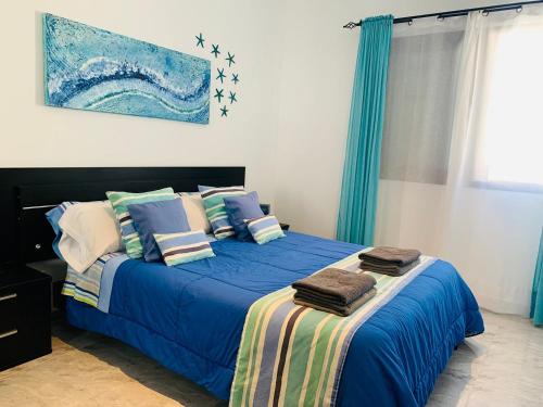 コティージョにあるAtlantic Green 3のベッドルーム1室(青いシーツと枕のベッド1台付)