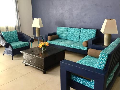 a living room with blue couches and a coffee table at My Beach Condo RG5 in Puerto Vallarta