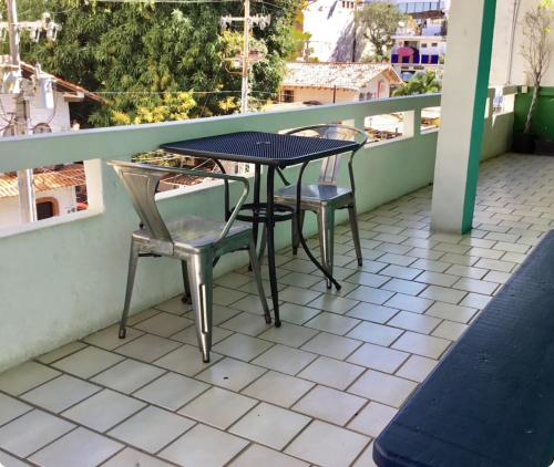 a table and two chairs on a balcony at My Beach Condo RG5 in Puerto Vallarta