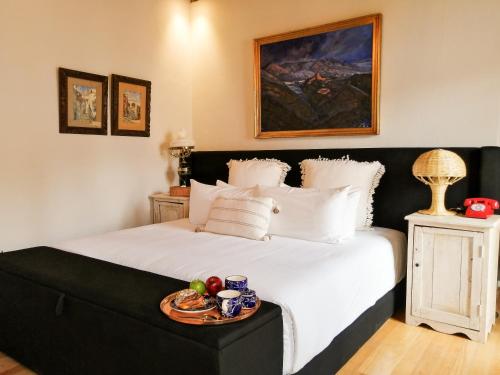 a bedroom with a bed with a tray of food on it at Casona Alonso 10- Hotel Boutique in Guanajuato
