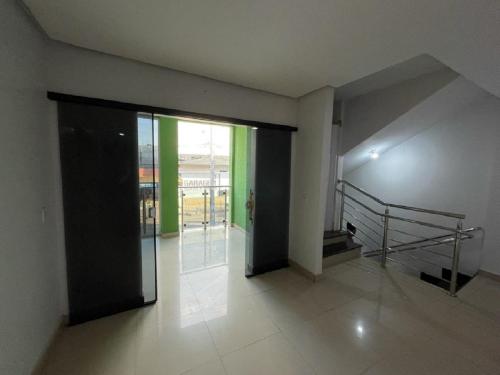 a hallway with an open door to a building at Hotel Oliveira 44 in Goiânia