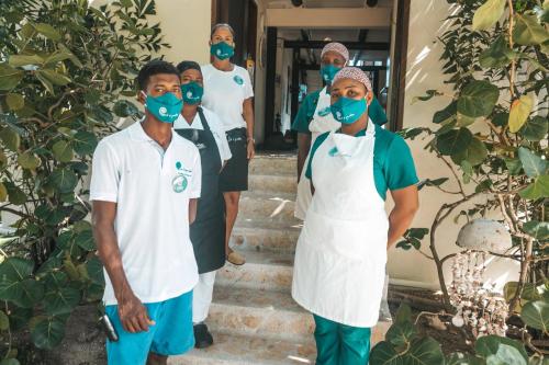 a group of doctors wearing masks walking down the stairs at Tintipan Cabana SalSiPuedes in Tintipan Island