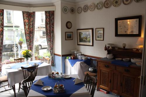a dining room with two tables and a window at Bluestones in Keswick