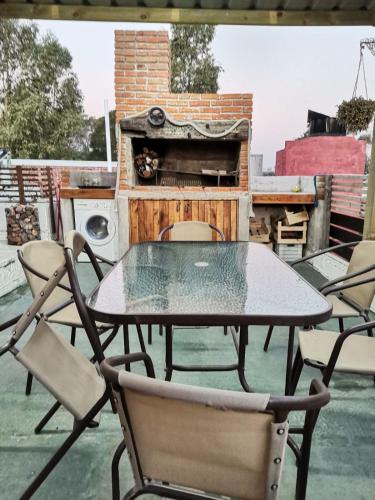 a table and chairs on a patio with a stove at Apart en playa hermosa piriapolis a dos cuadras de la playa in Piriápolis