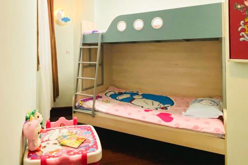 a bedroom with two bunk beds with a ladder at C&D Resort,Wuyi Mountain in Wuyishan