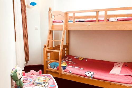 a childs bedroom with two bunk beds and a ladder at C&D Resort,Wuyi Mountain in Wuyishan