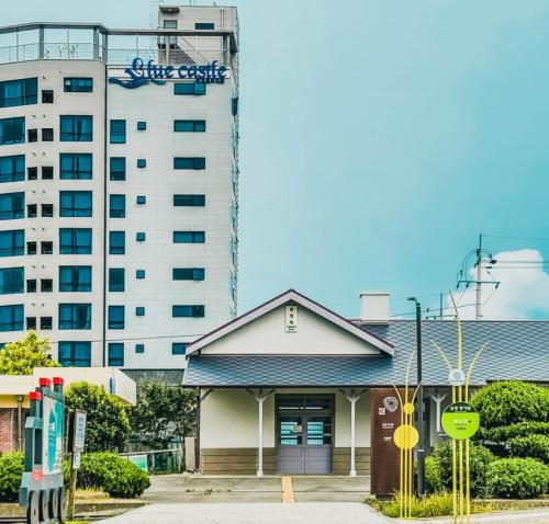 a building in front of a tall building at Songjeong Blue Castle Hotel in Busan