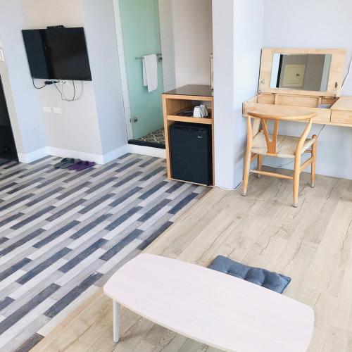 a living room with a couch and a table and a tv at One Way B&B in Hualien City