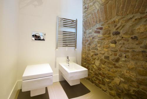 a bathroom with a sink and a stone wall at Residenza Amblingh in Vasto