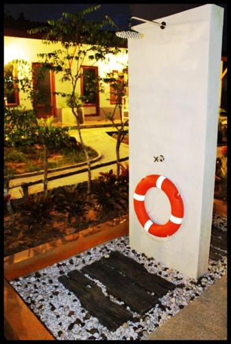 a door with a life preserver on the side of a building at Phuket Muay Thai House in Chalong 