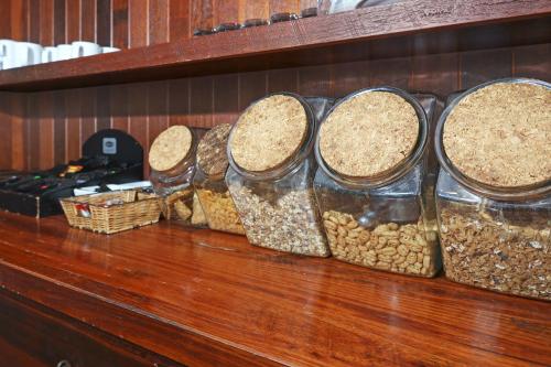 a row of glass containers filled with cereals and peanuts at Thunderbird Motel Yass in Yass