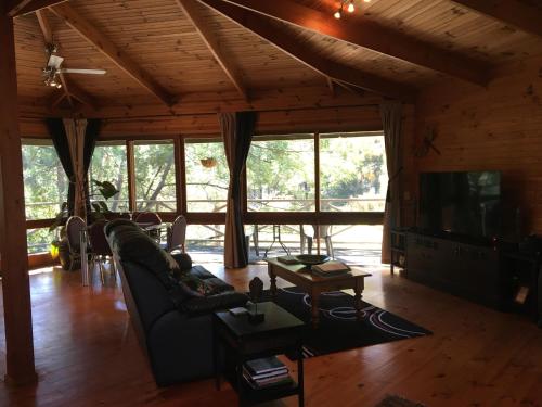 a living room with a couch and a tv at Sea Nest in Batemans Bay