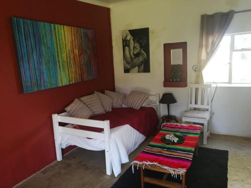 a bedroom with a bed and a colorful wall at Klipfontein Rustic Farm & Camping in Tulbagh