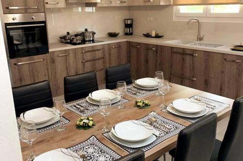 a kitchen with a table with plates and glasses on it at Helen`s Luxury Apartment in Heraklio Town