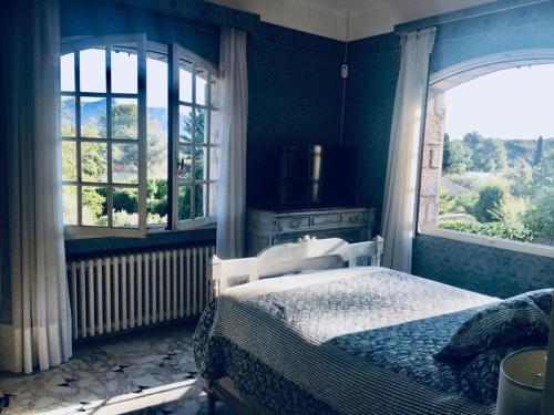 a bedroom with a bed and a large window at Villa La Pastorale in Saint Paul de Vence