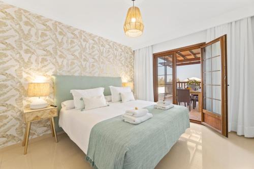 a bedroom with a bed with towels on it at Lanzarote Villa Vista Lobos 47 in Playa Blanca