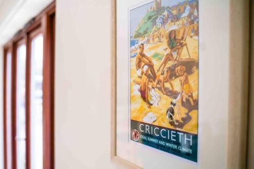 a poster of a movie on a wall at Bwthyn Bach Cozy country retreat in Criccieth