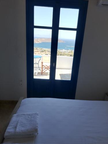 a bedroom with a bed and a view of the ocean at Tirquaz View in Serifos Chora