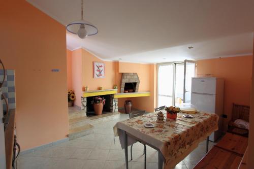 a kitchen with a table and a fireplace in it at Bed and Breakfast Vibo Mare in Vibo Valentia Marina