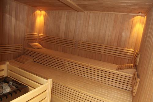 an empty sauna with wooden walls and wooden floors at JUFA Hotel Hochrindl in Hochrindl