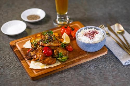 a plate of food with rice and a bowl of food at Rydges Armidale in Armidale