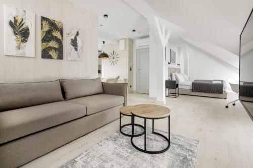 a living room with a couch and a table at Apartamenty L11, Limanowskiego in Poznań