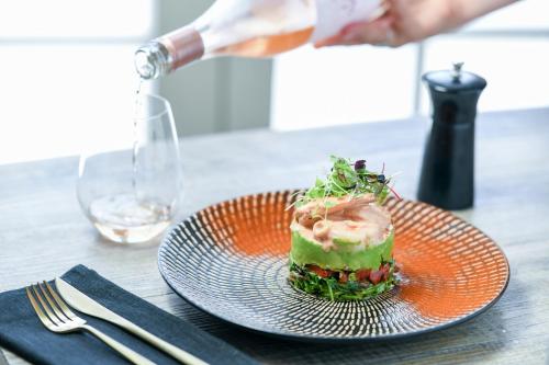 a plate with a piece of food on a table at Rydges Armidale in Armidale