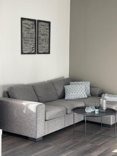 a living room with a couch and a table at Torggatan 54 in Mariehamn