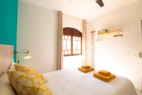 a bedroom with a bed with two towels on it at Quinta do Paraíso - Bed&Shower in Albufeira