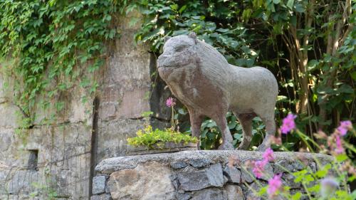 a statue of a sheep standing on a stone wall at Résidence SoAnSa du Gérardmer - Col de la Schlucht in Soultzeren