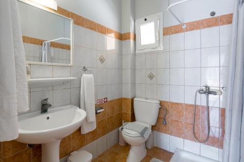 a bathroom with a sink and a toilet and a shower at Makis studios By La skala Vista in Skala Kefalonias