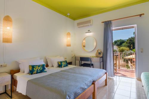 a bedroom with a bed and a balcony at Makis studios By La skala Vista in Skala Kefalonias