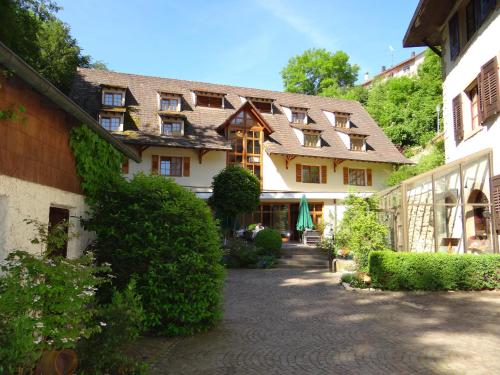 a large building with a pathway in front of it at Hotel-Restaurant Bibermühle GmbH in Tengen