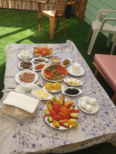 a table with many plates of food on it at צימר גבול החרמון in Majdal Shams