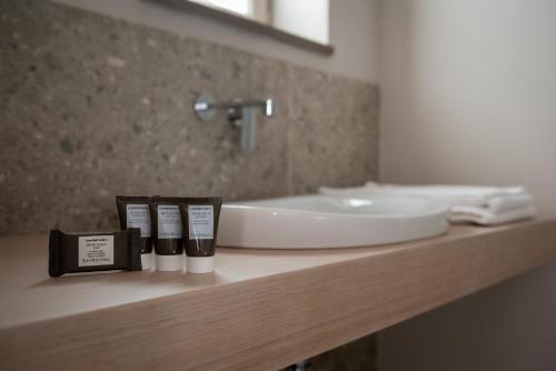 a bathroom counter with a sink and a mirror at Tenuta Pizzone Wine Resort in Rivanazzano