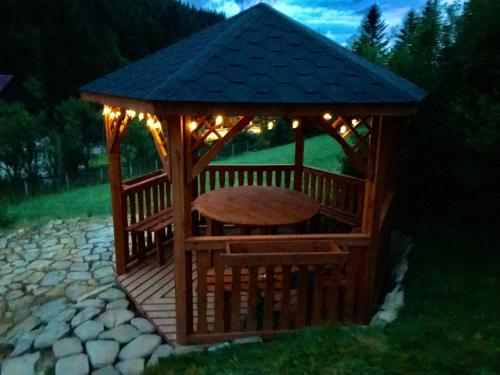 a gazebo with a table and lights on it at Villa Eva & Lilou Pod Rysianką in Żabnica