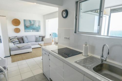 a kitchen with a sink and a living room at Dreamy Sea View Accommodation Gran Canaria in San Agustin
