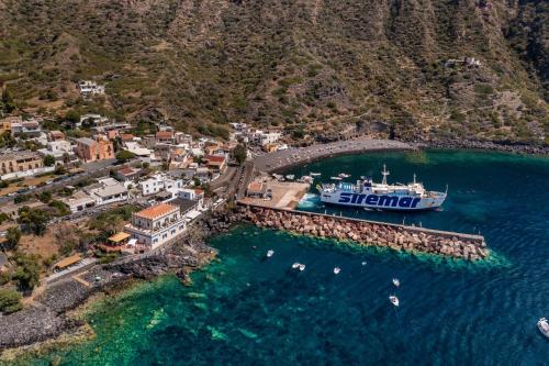 a boat is docked at a dock in the water at Hotel L'Ariana ISOLE EOLIE - UNA Esperienze in Leni