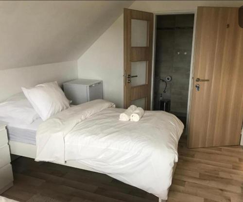 a white bed with two towels on top of it at Apartment Oskar in HoÅ¡Å¥ka