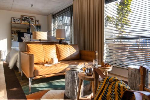 a living room with a couch and a table at Villa M in Paris