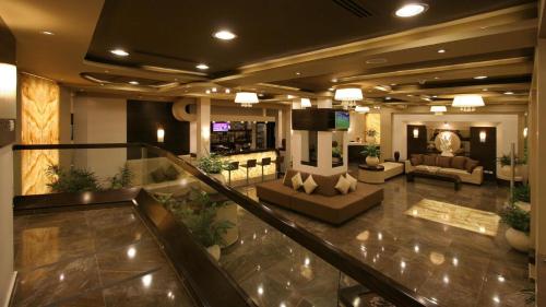 a lobby with a couch and a television in a building at Saint Michael Hotel in Bethlehem