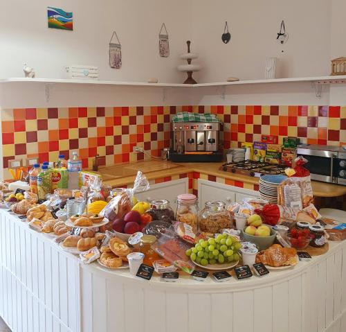 a table with a bunch of food on it in a kitchen at Demetra Malophoros in Marinella di Selinunte