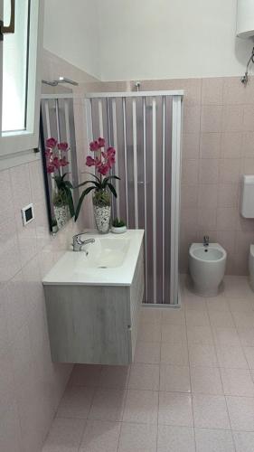 a bathroom with a sink and a toilet at CASA VACANZA "Adamo" in Racale