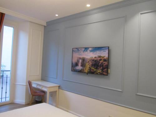 a room with a wall with a painting on it at Hotel Borgovico in Como