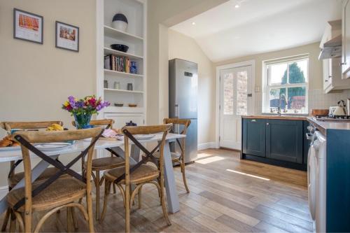 a kitchen and dining room with a table and chairs at Spencer House in York