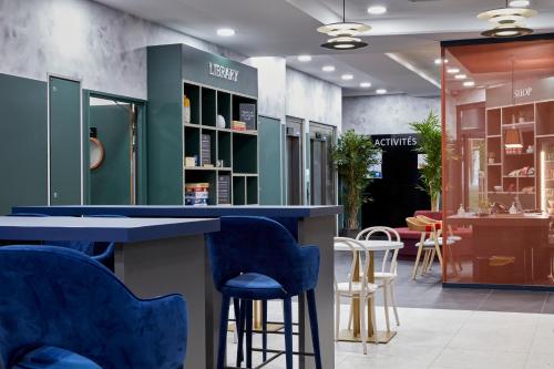 a store with blue bar stools and chairs at Aparthotel Adagio Paris Suresnes Longchamp in Suresnes