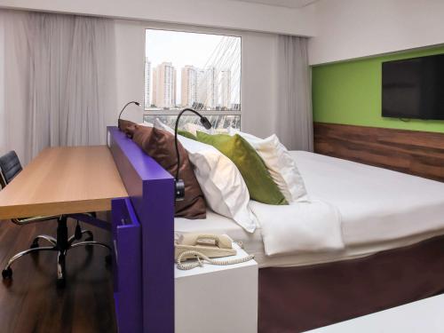 Кровать или кровати в номере Mercure Sao Jose dos Campos