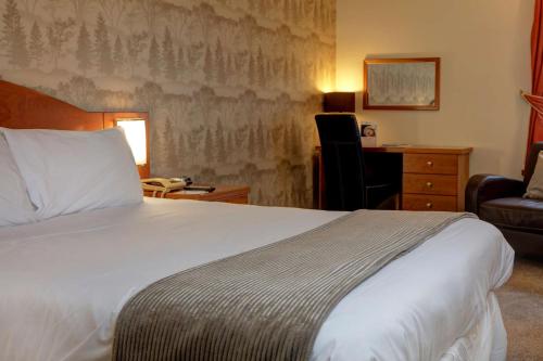 a bedroom with a bed and a desk and a chair at Hotel St Pierre, Sure Hotel Collection by Best Western in Wakefield